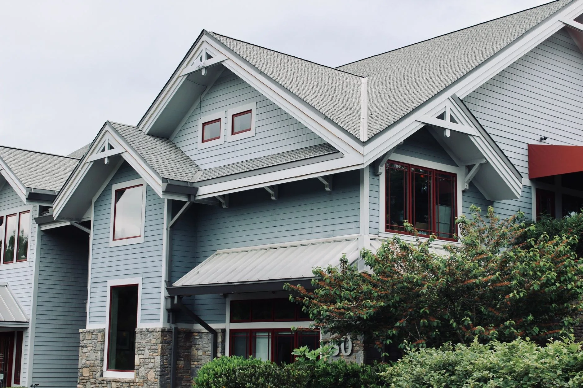 Before: worn, faded asphalt shingle roof before replacement